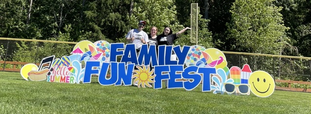 Damon Townsend supporters at a Family Fun Fest sign